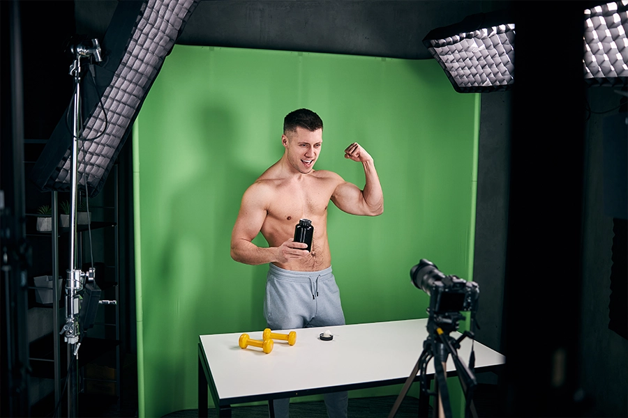 Athletic young man recording video for bodybuilding vlog 
